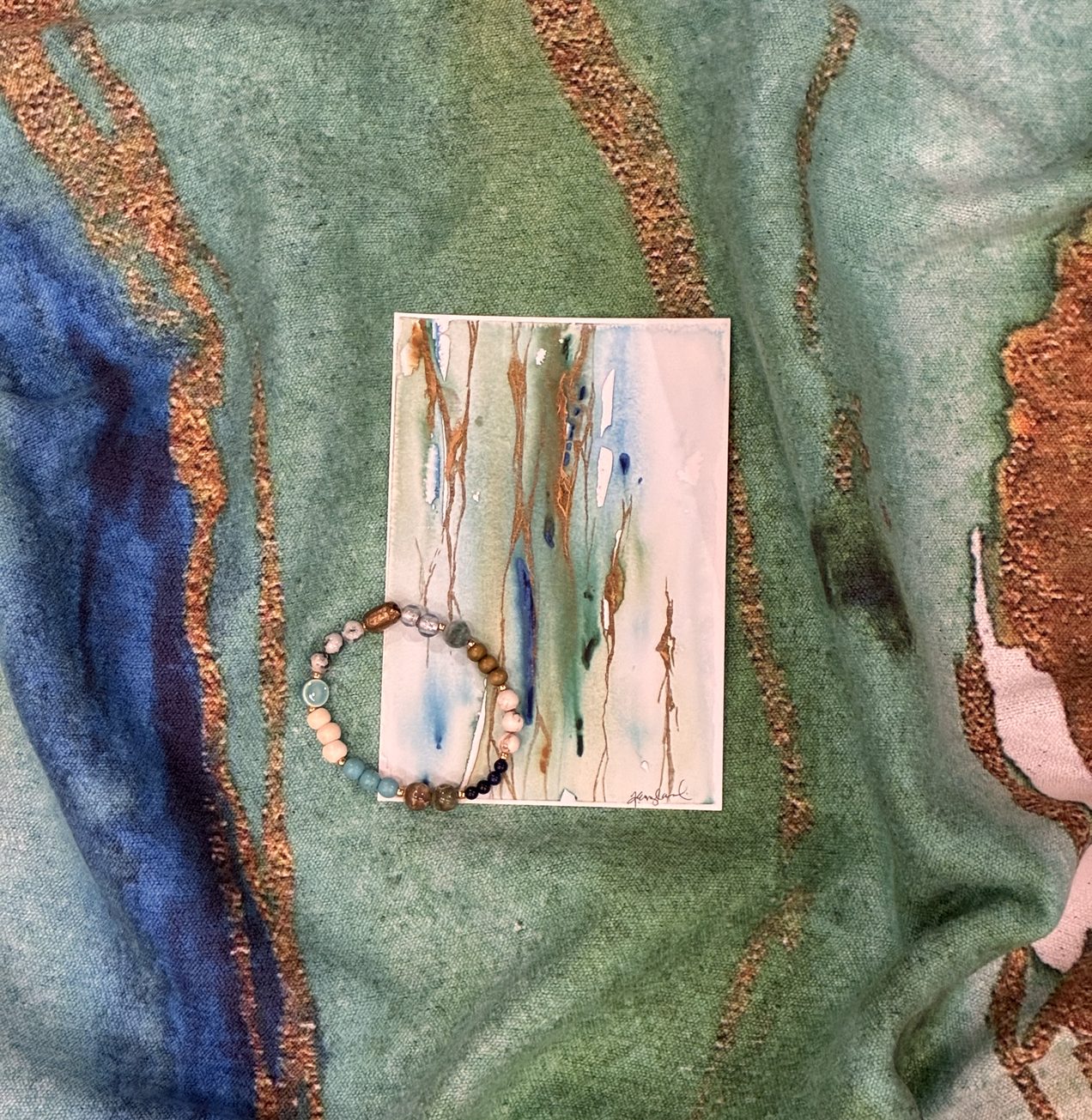 Illumination towel with the 4x6 print and a handmade bracelet